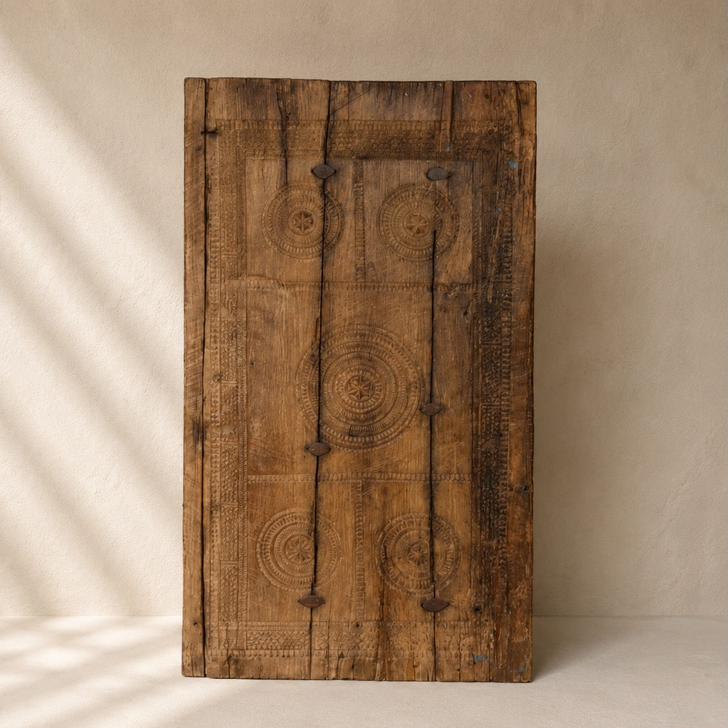 One-of-a-kind vintage Indian wooden wall panel with hand-carved geometric motifs and aged metal detailing, exclusive to Brookfield Gardens.