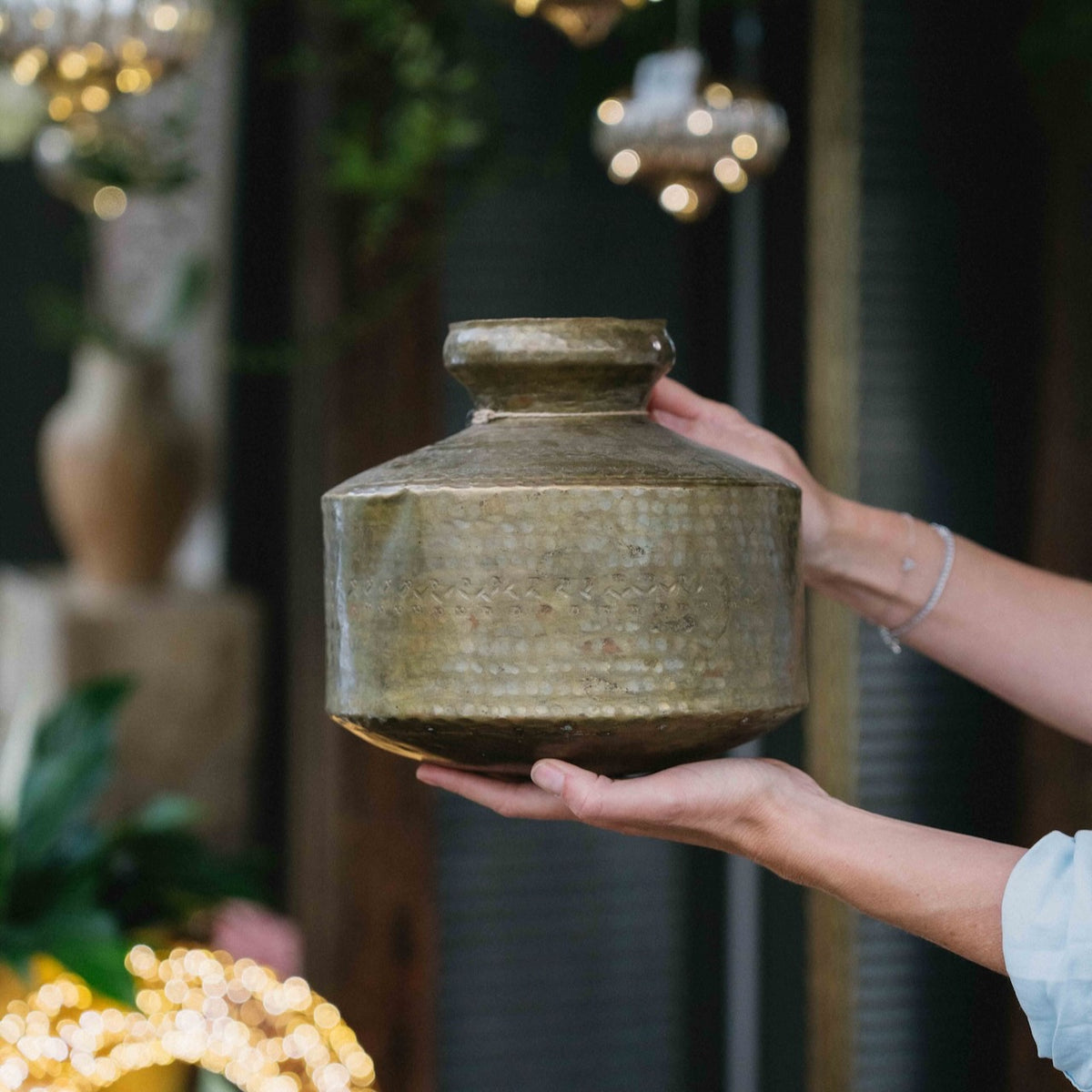 Vintage Indian brass mini vase, 22cm, featuring a rounded body, narrow neck, hammered detailing and aged golden patina, exclusive to Brookfield Gardens.