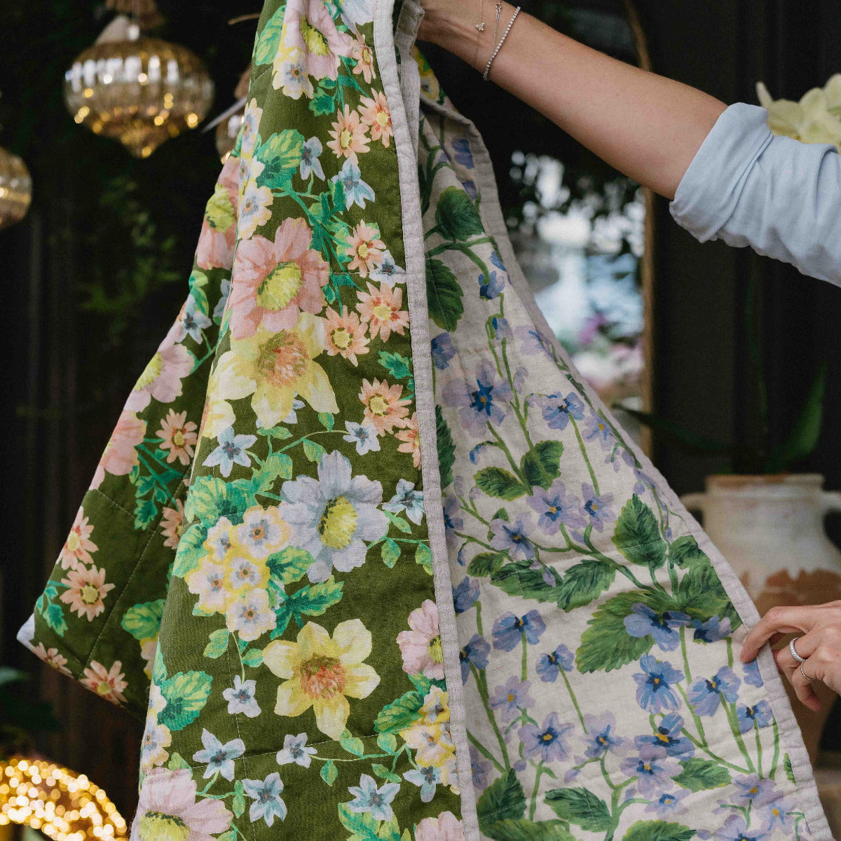 Bonnie & Neil Buttercup Olive & Lilas Blue reversible linen quilted throw featuring botanical floral prints in olive green and blue.