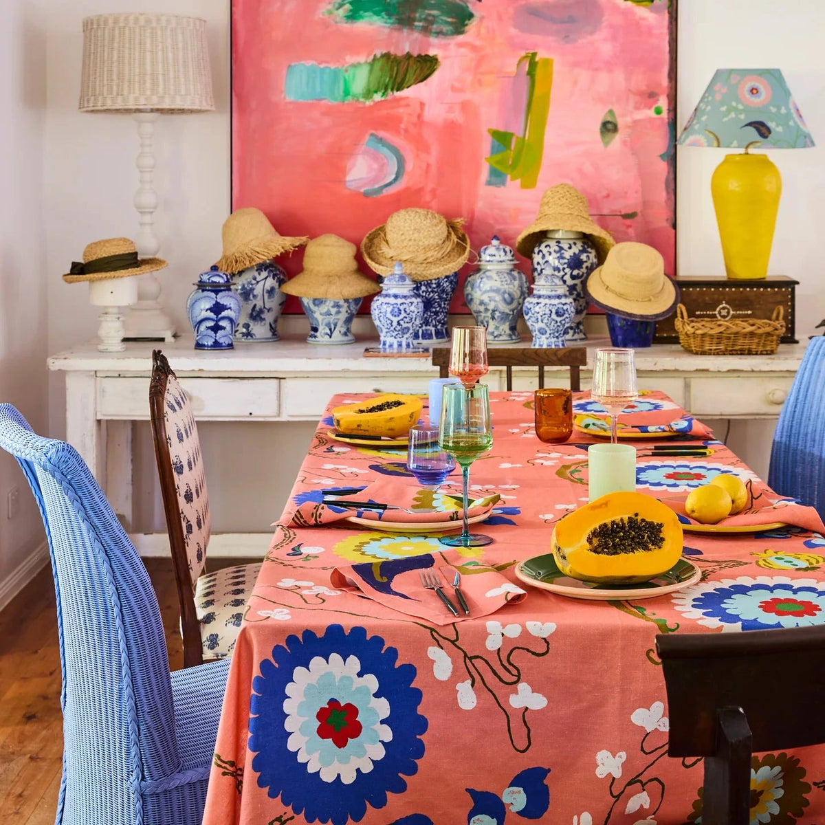 Kip & Co x Anna Spiro Isabelle Sunset Tablecloth featuring oversized multicoloured florals on a coral pink background.