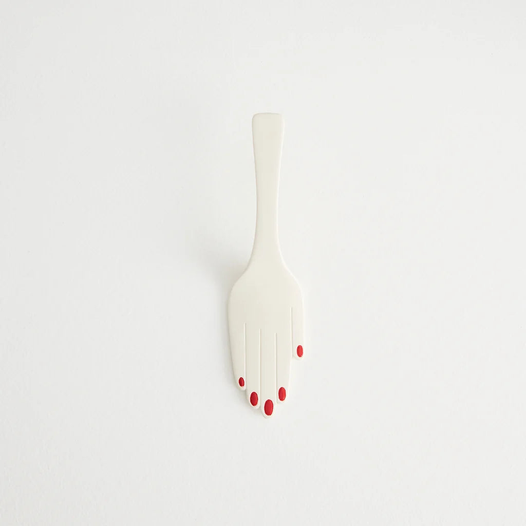 Maison Balzac ivory glazed ceramic hand-shaped cake server with glossy red fingernails.