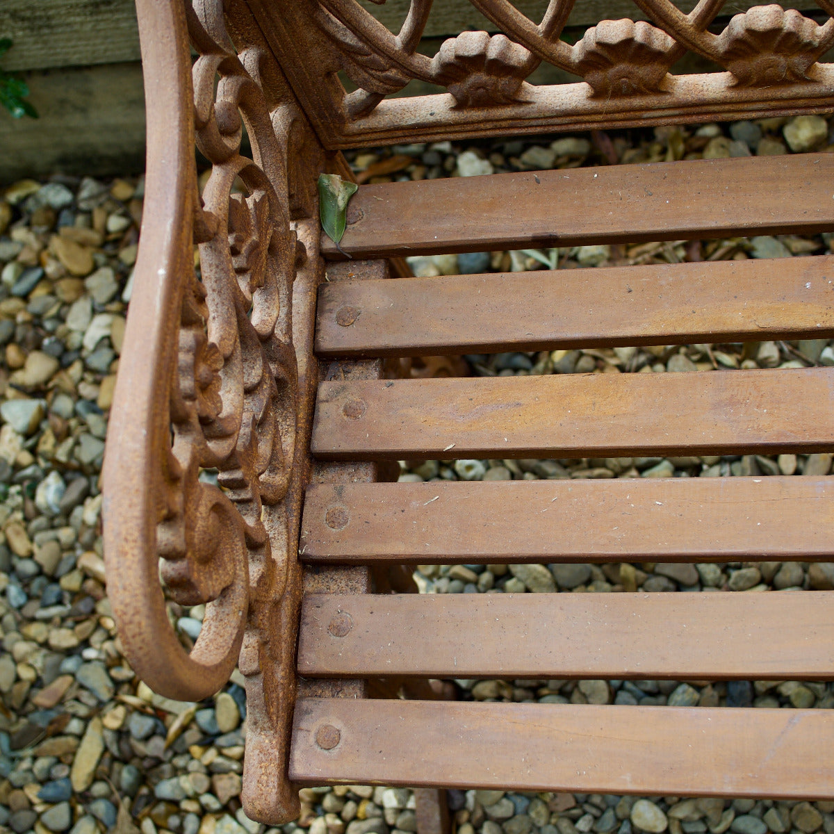 ornate Shelly garden bench with decorative detailin
