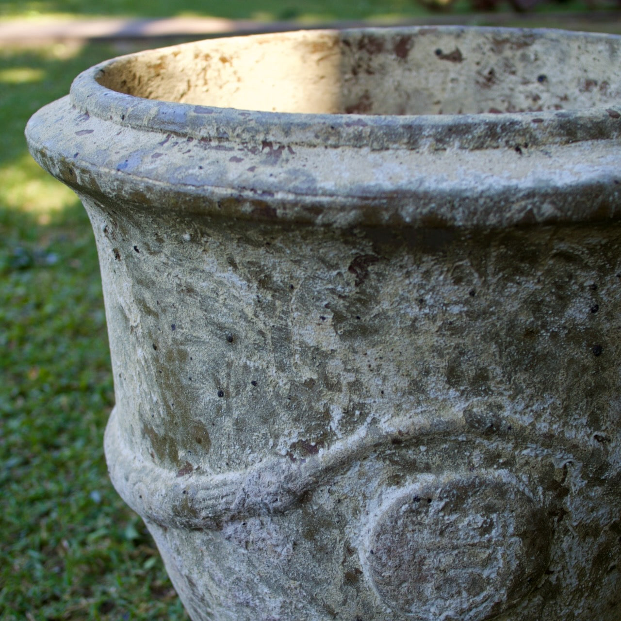 Rustica Anduze urns in two sizes with a weathered antique finish, displayed as elegant French-inspired feature pots at Brookfield Gardens, Brisbane.