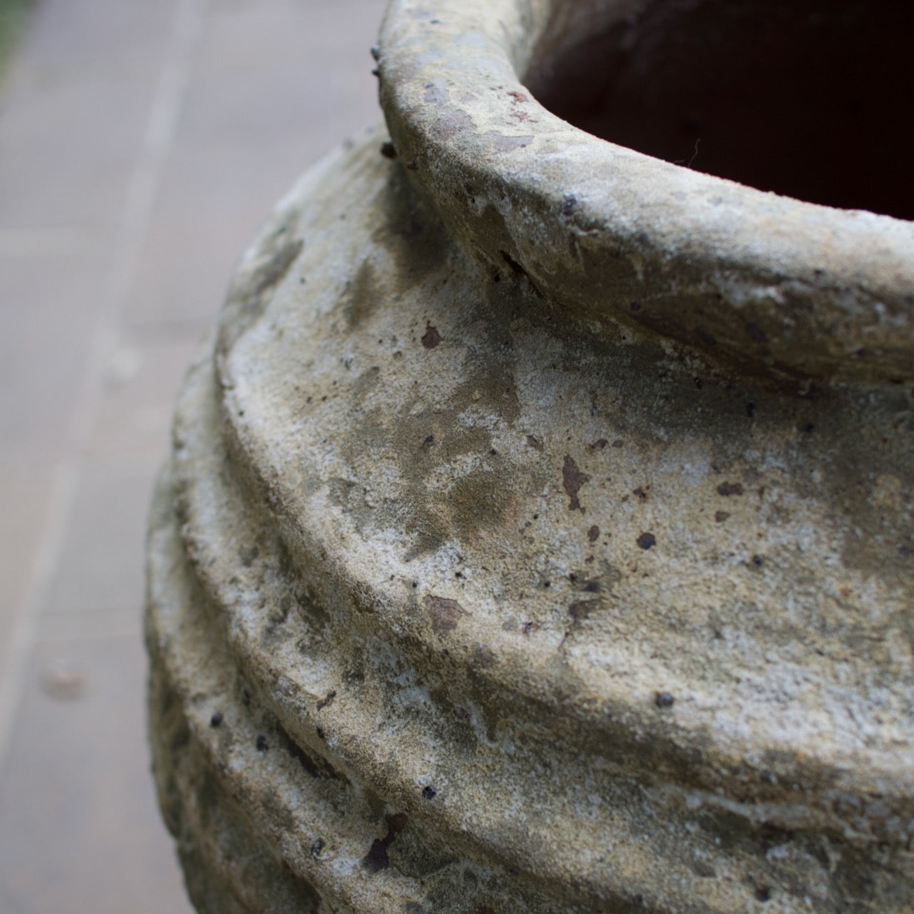 Rustica Bella Urn with a textured ribbed design and weathered antique finish, displayed as a Mediterranean-inspired feature planter at Brookfield Gardens, Brisbane.