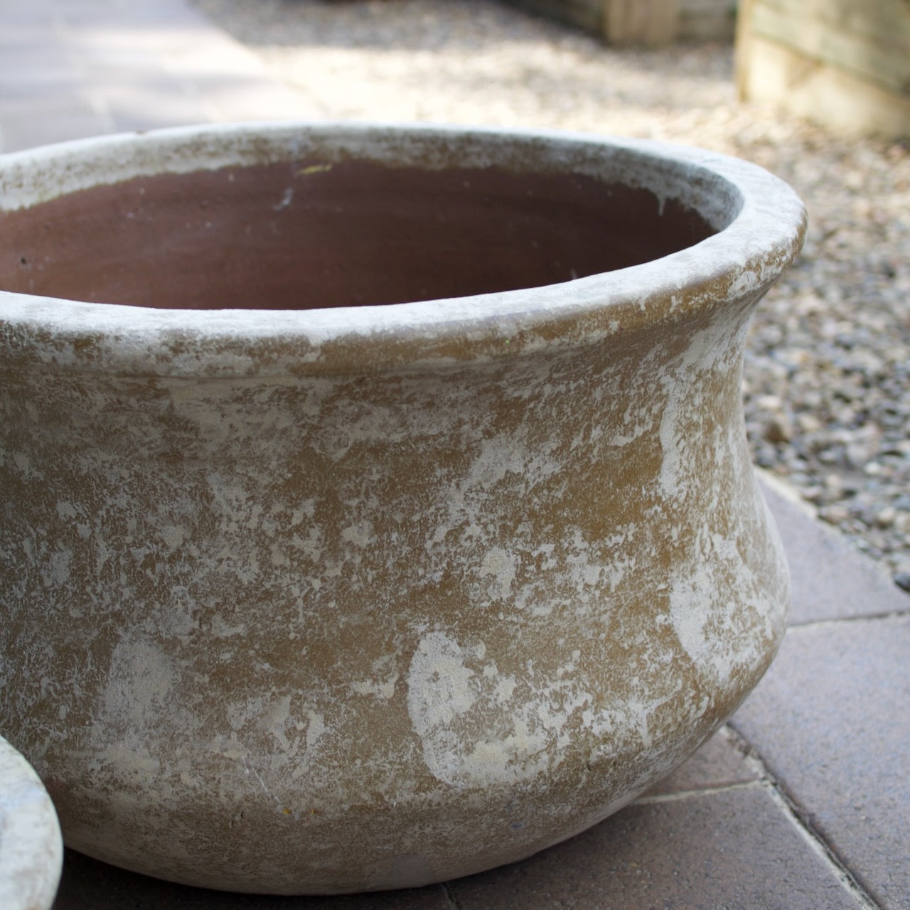 Rustica Low Lotus Pots in multiple sizes with a weathered antique finish, displayed as elegant feature pots at Brookfield Gardens, Brisbane.