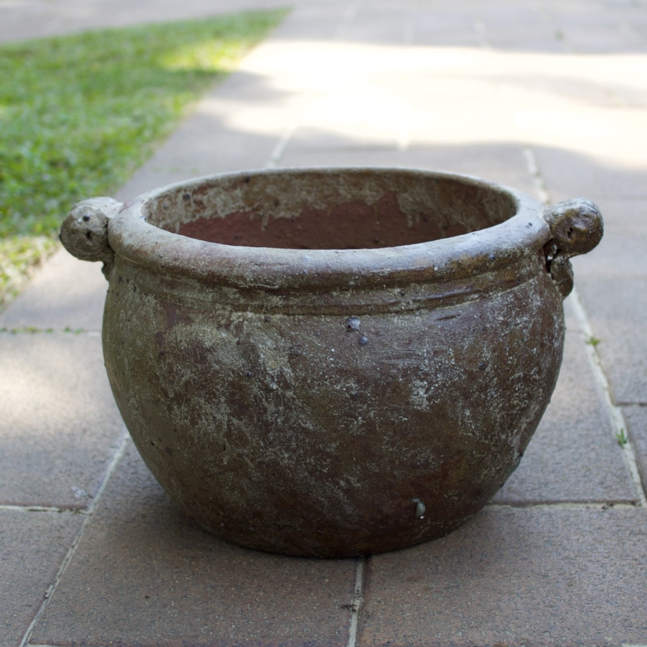 Rustica Rolled Handles Pots in two sizes with a weathered antique finish, displayed as Mediterranean-inspired feature pots at Brookfield Gardens, Brisbane.