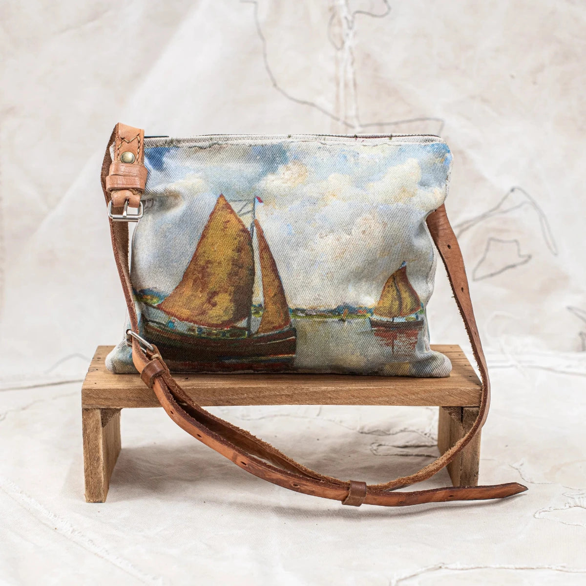 Swarm Ocean Landscape Cross Body Bag with painterly sailing boat design, aged leather strap and magnetic closure.