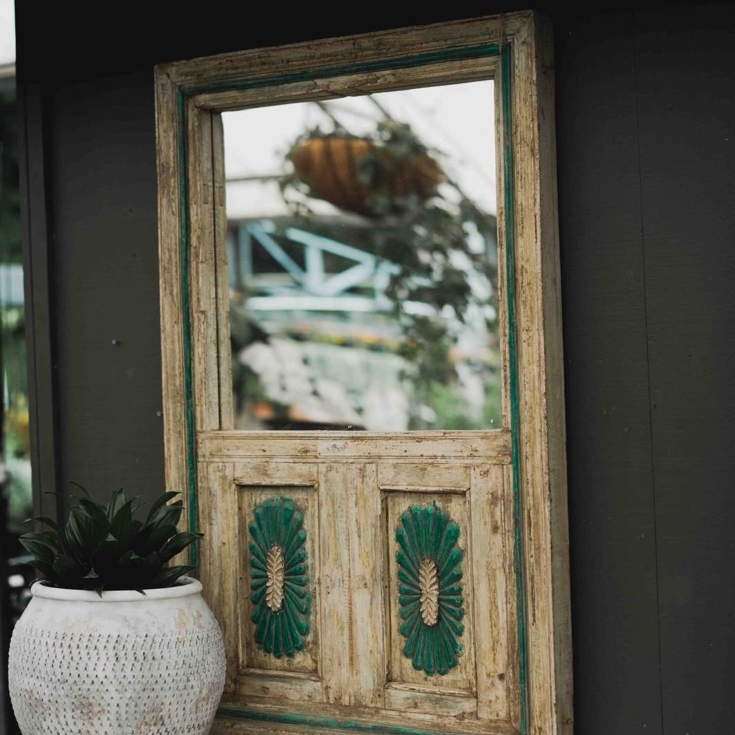 Vintage wooden mirror crafted from reclaimed timber with distressed green detailing, adding rustic character to a home or garden room.